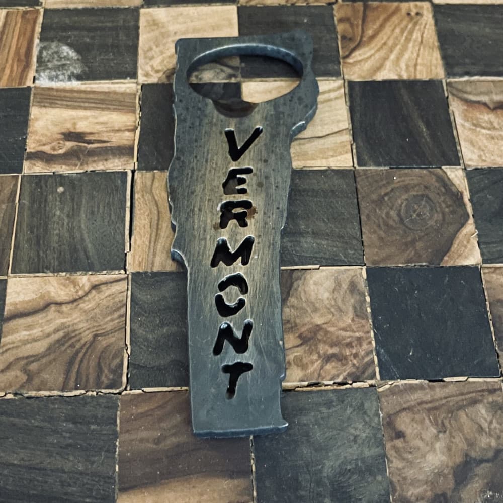 A hand-forged bottle opener in the shape of Vermont