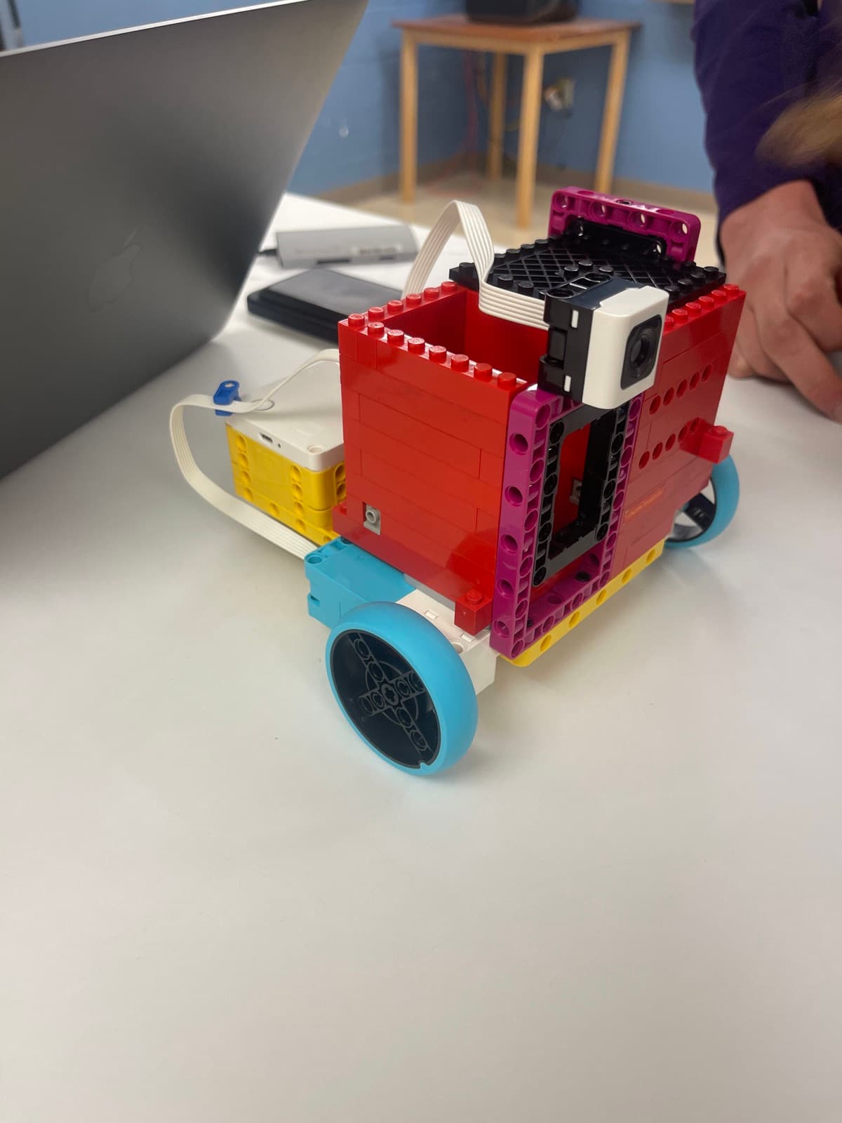 A Lego robot built on a wheeled chassis with a camera module