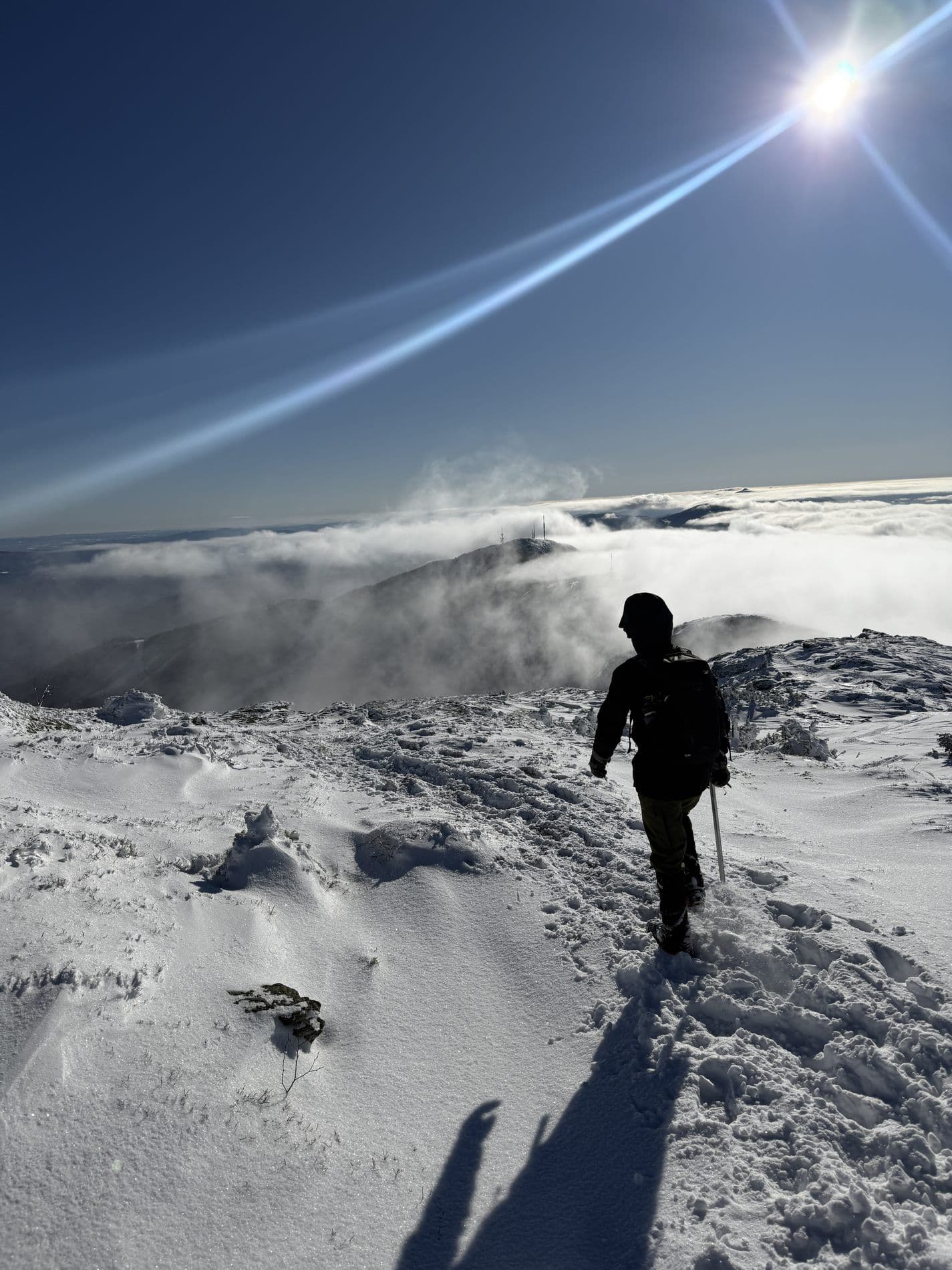 A wide view along a windswept snow ridge