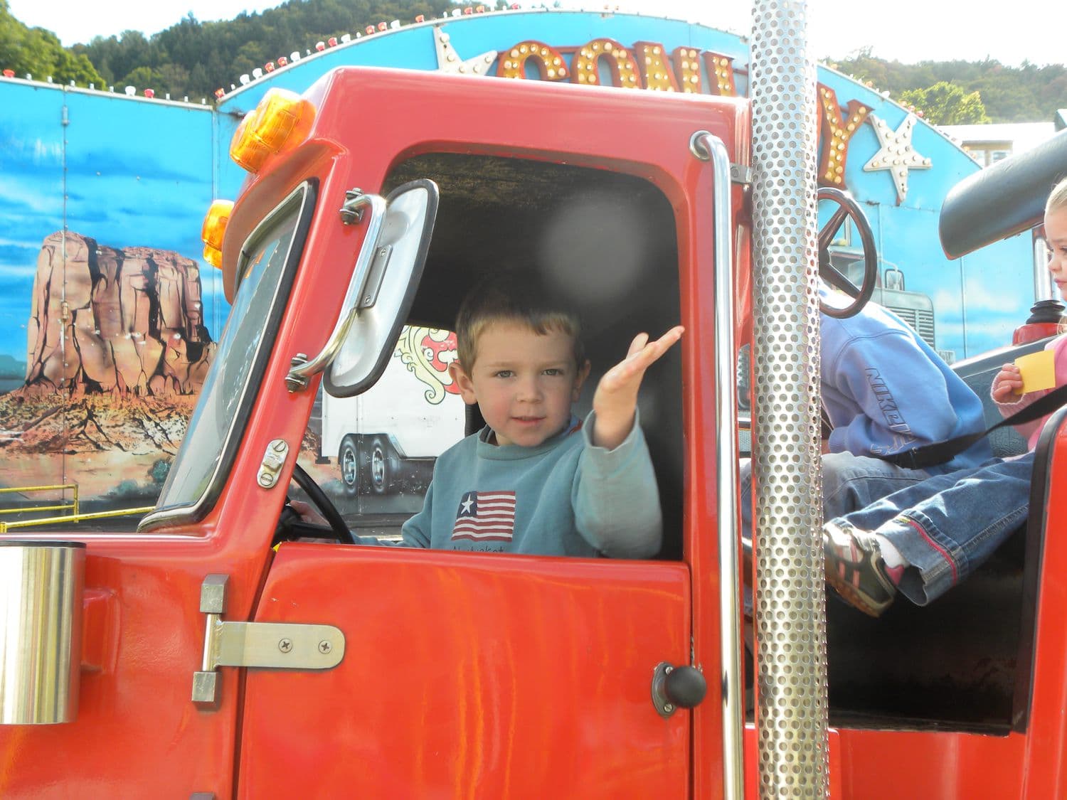 Judson as a small boy waving from the cab of a red truck