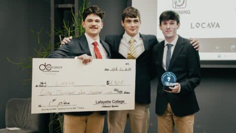 Judson Dunne with Will Gottfried and Ethan Melgar holding the $1,500 first-place cheque at the Dyer Center Big Idea Pitch Competition